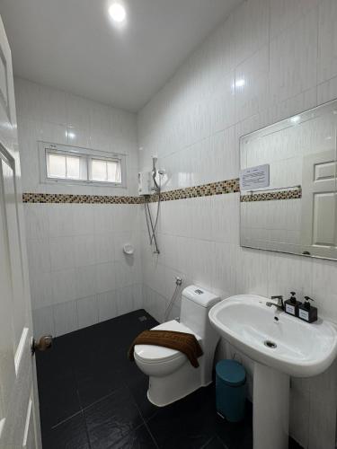 a white bathroom with a toilet and a sink at Relax private Pool Villas - 4 bedroom villas in Ao Nang Beach