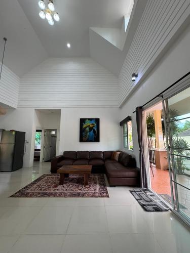a living room with a couch and a coffee table at Relax private Pool Villas - 4 bedroom villas in Ao Nang Beach