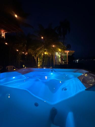 a blue jacuzzi tub in a yard at night at Cabana do Mar in Angra dos Reis