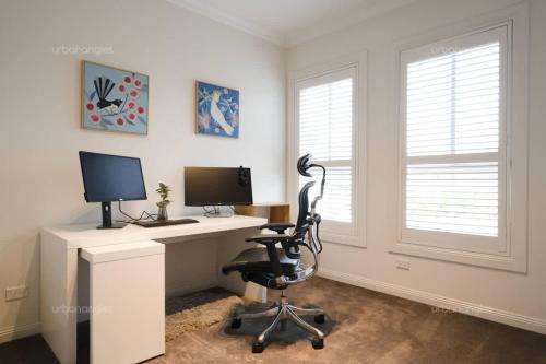 an office with a desk with a computer and a chair at Luxurious Georgian Style Family Home with Cinema in Templestowe Lower