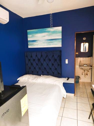 a blue bedroom with a bed and a sink at Habitacion 11 independiente con mucha privacidad ,cerca del consulado , CAS , a 200 mts del vado del rio in Hermosillo