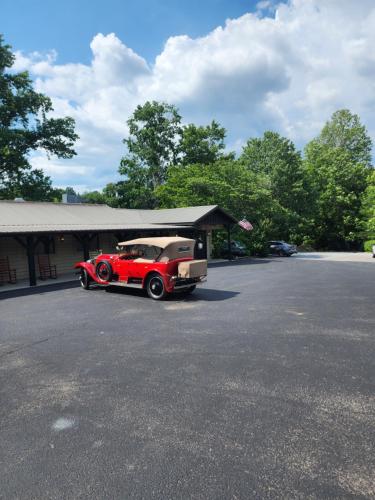 a red car parked in front of a building at Lodge At Tellico in Tellico Plains