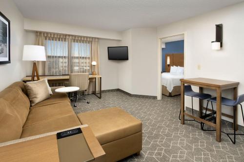a hotel room with a couch and a desk and a bed at Residence Inn Denver South/Park Meadows Mall in Centennial