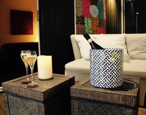 a bottle of champagne and wine glasses on end tables at 187 Merrijig in Merrijig