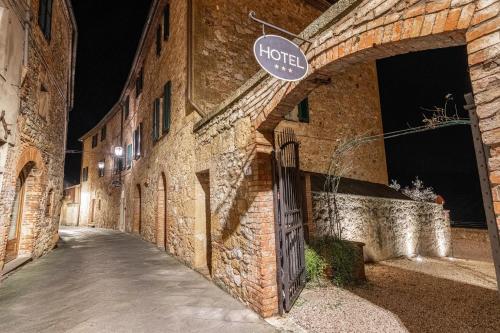 a brick building with a sign that reads hotel at Palazzo Brandano Hotel in Petroio