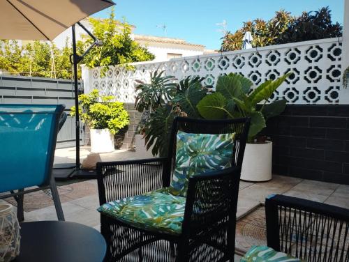 a chair with a pillow on a patio at Casa Gares in Peñíscola