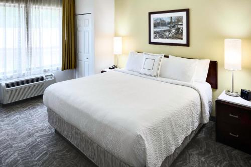 a hotel room with a large bed and a window at SpringHill Suites Milford in Milford