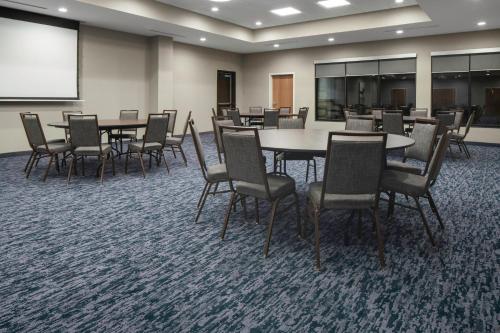 a conference room with tables and chairs and a whiteboard at Fairfield Inn & Suites by Marriott Corinth South Denton Area in Corinth