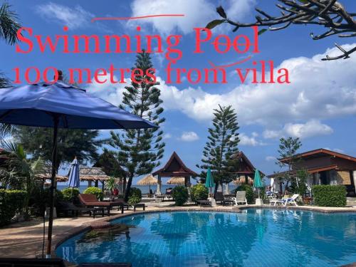 a pool at a resort with the words swimming pool metres from villa at Prukrom Lanta Villa in Ko Lanta