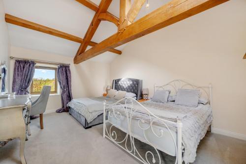 a bedroom with two beds and a window at 5-Bed Country Retreat in Harrogate with Hot Tub in Harrogate
