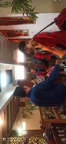 a group of people are standing in a room at Hotel Shraddha Palace in Kathmandu