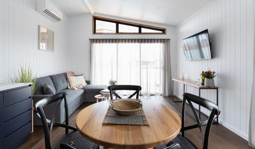 a living room with a table and chairs and a couch at Whitton Malt House in Whitton
