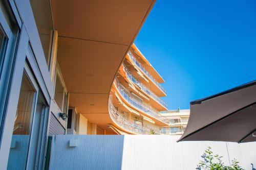 a building with awning on the side of it at Villa Bono Jacuzzi & Spa in Saint-Laurent-du-Var