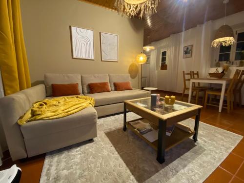 a living room with a couch and a table at Ribeira dos Caldeirões in Achada