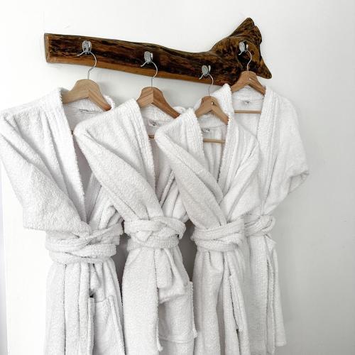 a group of white towels hanging on a wall at Homestay Pachamama in Cabanaconde