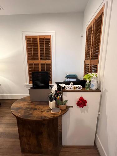 a room with a table and a refrigerator at MyCrib Houston Hostel in Houston