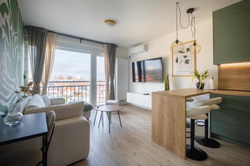 Μια τηλεόραση ή/και κέντρο ψυχαγωγίας στο Apartment Oasis