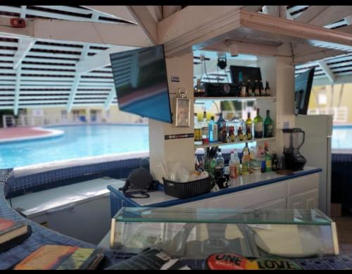 a bar in front of a swimming pool at Comfort Zone at The Ridge E17 in Ocho Rios