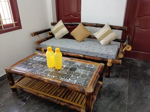 two yellow vases sitting on top of a table at Mithila Eco Stay - Explore chettinad in Mithilaipatti