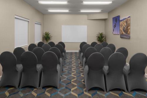 a conference room with black chairs and a whiteboard at Residence Inn by Marriott Santa Clarita Valencia in Santa Clarita