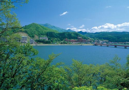 a large body of water with a city and mountains at Art Hotel Morioka in Morioka