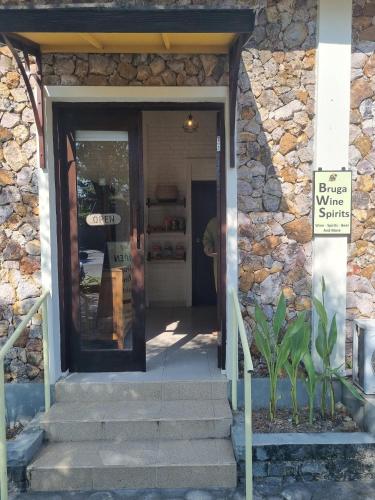 a entrance to a building with a stone wall at Bruga Villas Restaurant and Spa in Selong Belanak