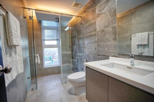 a bathroom with a toilet and a sink and a shower at URBAN PALACE in Phnom Penh