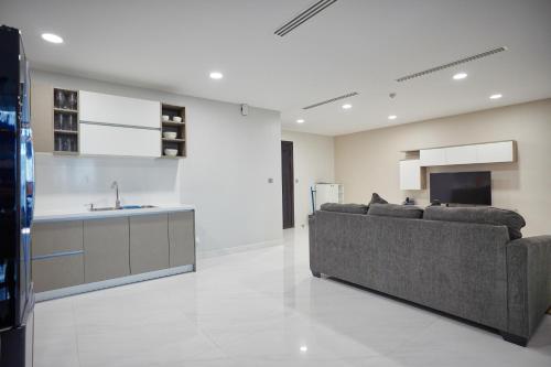 a living room with a couch and a kitchen at URBAN PALACE in Phnom Penh
