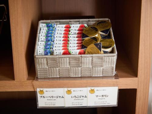 a shelf with two baskets filled with different types of ties at Sun Palace Kyuyokan in Naha