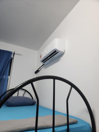 a room with a bunk bed with a light above it at Homestay Zaishazali in Gelugor