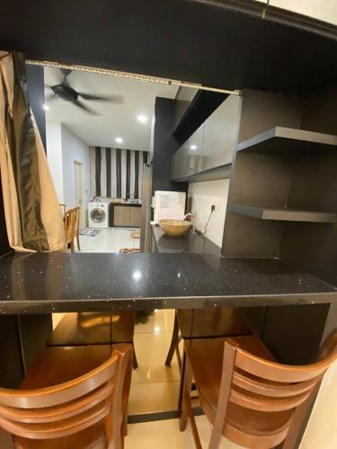 a kitchen with a table and chairs in a room at home hijayu sendayan seremban n9 in Siliau