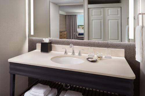 a bathroom with a sink and a mirror at Sheraton Imperial Hotel Raleigh-Durham Airport at Research Triangle Park in Durham