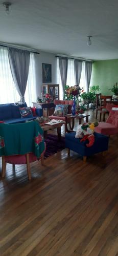 a living room with couches and tables in a room at Casa para ferias manizales in Manizales