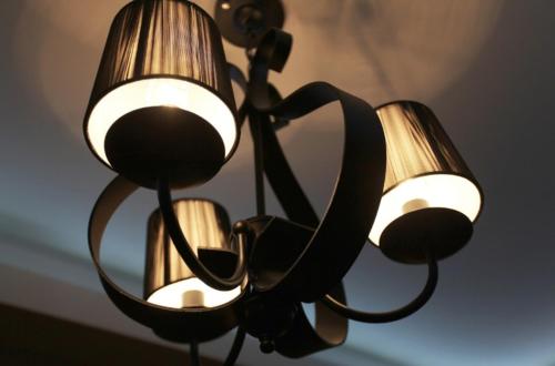 a chandelier hanging from a ceiling with lights at Shampoo Hotel Incheon in Incheon