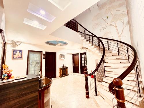a staircase in a house with a painting on the wall at South Inn - Green Park South Delhi in New Delhi