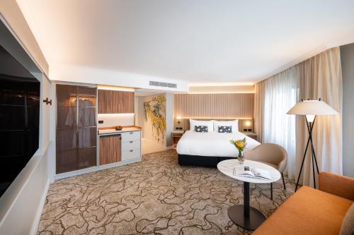 a hotel room with a bed and a table at PARKROYAL Parramatta in Sydney