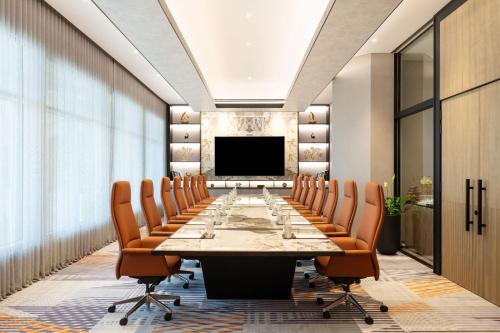 a large conference room with a long table and chairs at Sheraton Mall of the Emirates Hotel, Dubai in Dubai