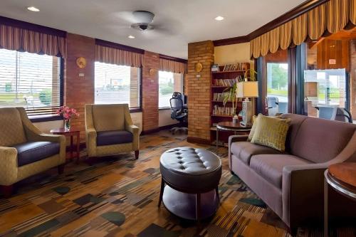 a living room with a couch and a table and chairs at Park Inn by Radisson in Grove City