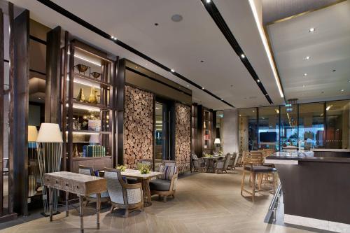 a restaurant with tables and chairs and a bar at Sheraton Hua Hin Resort & Spa in Cha Am