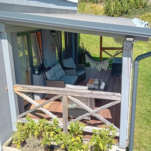 a screened in porch with a couch and a hammock at Haus Mozart in Schladming