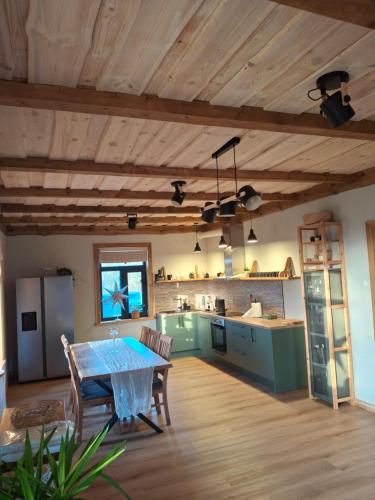 a large kitchen with a table in a room at Guest house Kalnieši in Madona