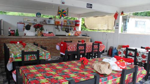 a room with two tables and chairs with christmas presents at El Rincón Preferido in Papantla de Olarte