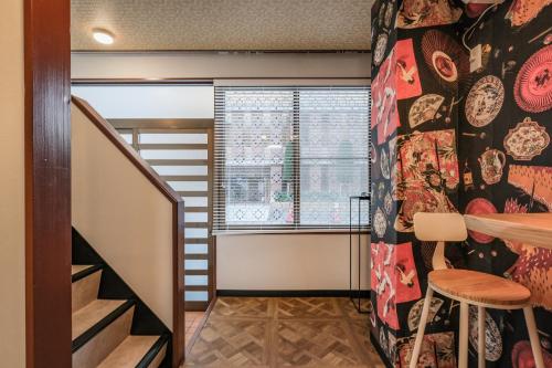 a small room with a staircase and a window at Fuukanto Kinshicho BNB in Tokyo