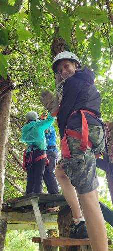 a man and two children climbing up a tree at Hostal Xilotl in San José del Sur