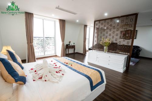 Ένα ή περισσότερα κρεβάτια σε δωμάτιο στο New Century Hotel