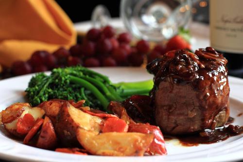 a plate of food with meat and vegetables on a table at St. Petersburg Marriott Clearwater in St Petersburg