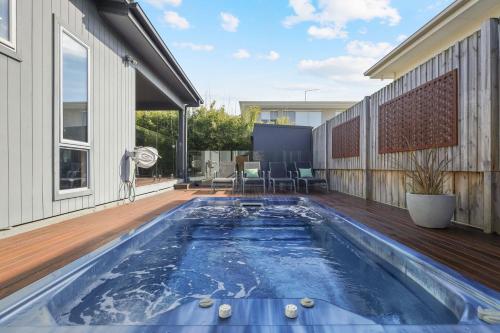 a swimming pool on the deck of a house at Mingalar in Cowes