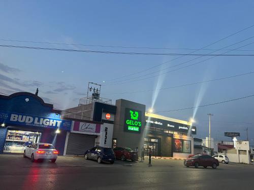 a city street with cars parked in front of stores at San Felipe Excelente ubicacion in Chihuahua