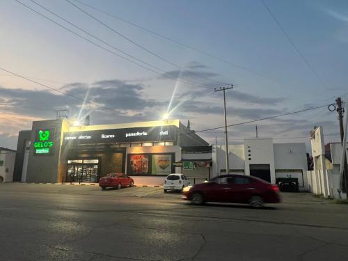 a store with two cars parked in a parking lot at San Felipe Excelente ubicacion in Chihuahua