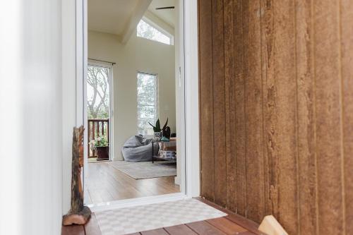 an open door into a room with a living room at Port Kembla Laneway Cottage in Port Kembla